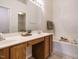 Bright bathroom featuring double sinks, a vanity area, and a soaking tub at 101 Lake Tillery Dr, Cary, NC 27519