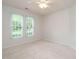 Neutral bedroom features carpet and large windows with blinds at 101 Lake Tillery Dr, Cary, NC 27519