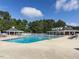 Large community pool with ample seating and shade from a gazebo and covered building at 101 Lake Tillery Dr, Cary, NC 27519