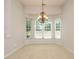 Elegant dining room featuring a bay window, neutral carpet, and a decorative chandelier for sophisticated gatherings at 101 Lake Tillery Dr, Cary, NC 27519