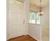 Bright foyer with hardwood floors, a stylish chandelier, and a view into a sunlit room, creating a warm welcome at 101 Lake Tillery Dr, Cary, NC 27519
