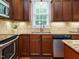 This kitchen boasts granite countertops, stainless steel appliances, and wooden cabinets for a modern feel at 101 Lake Tillery Dr, Cary, NC 27519