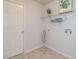 Efficient laundry room with shelving, washer hookups, and utility door to exterior at 101 Lake Tillery Dr, Cary, NC 27519