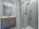 Bathroom featuring a glass enclosed tile shower, vanity and modern lighting at 1013 Poppy Fields Ln, Wake Forest, NC 27587