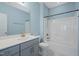Well-lit bathroom featuring vanity with gray cabinets and shower-tub combo at 1013 Poppy Fields Ln, Wake Forest, NC 27587