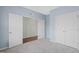 Carpeted bedroom with doors and a window at 1013 Poppy Fields Ln, Wake Forest, NC 27587