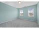 Empty bedroom with carpeted floor and two windows at 1013 Poppy Fields Ln, Wake Forest, NC 27587