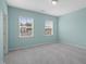 Carpeted bedroom with two windows at 1013 Poppy Fields Ln, Wake Forest, NC 27587
