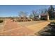 Historic park buildings with brick sidewalk and various trees at 1013 Poppy Fields Ln, Wake Forest, NC 27587