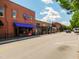 View of commercial street featuring storefronts and signage with blue skies and street parking at 1013 Poppy Fields Ln, Wake Forest, NC 27587