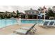 Community pool featuring lounge chairs, a lifeguard stand, and the club house in the background at 1013 Poppy Fields Ln, Wake Forest, NC 27587