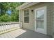 An outdoor deck featuring a window, door and awning, perfect for relaxation and privacy at 1013 Poppy Fields Ln, Wake Forest, NC 27587