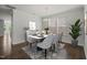 Bright dining room featuring modern decor, six chairs, and a large plant at 1013 Poppy Fields Ln, Wake Forest, NC 27587