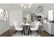 Elegant dining room with seating for six and modern chandelier at 1013 Poppy Fields Ln, Wake Forest, NC 27587