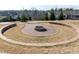Community fire pit with stone surround and circular patio for outdoor enjoyment at 1013 Poppy Fields Ln, Wake Forest, NC 27587