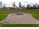 A community fire pit and outdoor seating area, surrounded by lush greenery at 1013 Poppy Fields Ln, Wake Forest, NC 27587