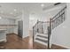 Open foyer area showcasing beautiful hardwood floors, staircase and access to the kitchen at 1013 Poppy Fields Ln, Wake Forest, NC 27587