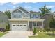 Charming two-story home featuring a welcoming front porch, attached garage, and professionally landscaped front yard at 1013 Poppy Fields Ln, Wake Forest, NC 27587