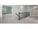 Upstairs hallway featuring gray walls, plush carpeting, and decorative metal handrail at 1013 Poppy Fields Ln, Wake Forest, NC 27587