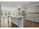 Modern kitchen featuring a granite island, stainless steel appliances, and ample cabinet space at 1013 Poppy Fields Ln, Wake Forest, NC 27587