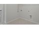 Simple laundry room with tile floor, connections, and wire shelving at 1013 Poppy Fields Ln, Wake Forest, NC 27587