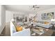 Bright, open-concept living room with modern furnishings and hardwood floors at 1013 Poppy Fields Ln, Wake Forest, NC 27587
