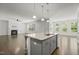Open floor plan view of living room and kitchen with fireplace and hardwood flooring at 1013 Poppy Fields Ln, Wake Forest, NC 27587