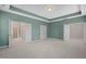 Spacious primary bedroom with tray ceiling, carpeting, and access to ensuite bathroom and closet at 1013 Poppy Fields Ln, Wake Forest, NC 27587