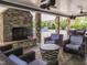Outdoor seating area with a stone fireplace overlooking the community pool at 1013 Poppy Fields Ln, Wake Forest, NC 27587