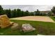 A community sand volleyball court with a net, surrounded by lush landscaping at 1013 Poppy Fields Ln, Wake Forest, NC 27587
