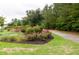 Scenic community walking path with lush landscaping and mature trees at 1013 Poppy Fields Ln, Wake Forest, NC 27587