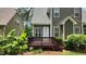 Wooden deck with stairs, surrounded by lush greenery and landscaping in the backyard at 1016 Dotson Way, Apex, NC 27523