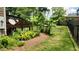 Well-maintained backyard with a wooden deck and beautiful tropical landscaping at 1016 Dotson Way, Apex, NC 27523