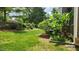 Lush backyard featuring green grass, mature trees, and well-maintained landscaping at 1016 Dotson Way, Apex, NC 27523