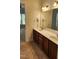 Bathroom with dual sinks, and wood cabinets, offering a comfortable and functional space at 1016 Dotson Way, Apex, NC 27523