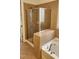Bathroom featuring glass enclosed shower with tiled surround and a soaking tub with tile surround and hardware at 1016 Dotson Way, Apex, NC 27523