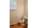 Cozy half bathroom features a classic white toilet and a window offering natural light at 1016 Dotson Way, Apex, NC 27523