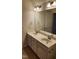 Bathroom with double sinks, neutral tile floors, and a large mirror above the vanity at 1016 Dotson Way, Apex, NC 27523