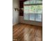 Bright dining room featuring hardwood floors, a chandelier, and a large window providing natural light at 1016 Dotson Way, Apex, NC 27523