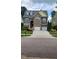 Charming two-story home featuring a stone facade, a two-car garage, and a beautifully landscaped front yard at 1016 Dotson Way, Apex, NC 27523