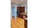 Kitchen area with wood floors, granite counters, stainless refrigerator and dishwasher at 1016 Dotson Way, Apex, NC 27523
