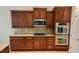 Gourmet kitchen featuring granite countertops, stainless appliances, and custom wood cabinetry at 1016 Dotson Way, Apex, NC 27523
