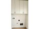 Functional laundry room with white cabinets, utility hookups, and neutral walls for easy customization at 1016 Dotson Way, Apex, NC 27523