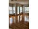 Spacious living area featuring wood floors and natural lighting with windows and doors at 1016 Dotson Way, Apex, NC 27523