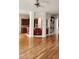 Open floorplan living room with wood floors, pillars and arches to adjacent room at 1016 Dotson Way, Apex, NC 27523