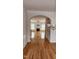 Open-concept layout with archway, hardwood floors, built-in shelves, and a fireplace, creating a spacious living area at 1016 Dotson Way, Apex, NC 27523
