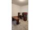 Well-lit office space featuring a large, u-shaped wooden desk with overhead storage and drawers at 1016 Dotson Way, Apex, NC 27523