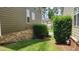 Landscaped side yard with lush greenery and stone accents at 1016 Dotson Way, Apex, NC 27523
