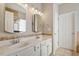 Bathroom featuring double sinks with white vanity and tile backsplash at 1016 Goldmist Ln, Durham, NC 27713
