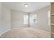 Neutral bedroom with carpet, two windows, and a ceiling light fixture at 1016 Goldmist Ln, Durham, NC 27713